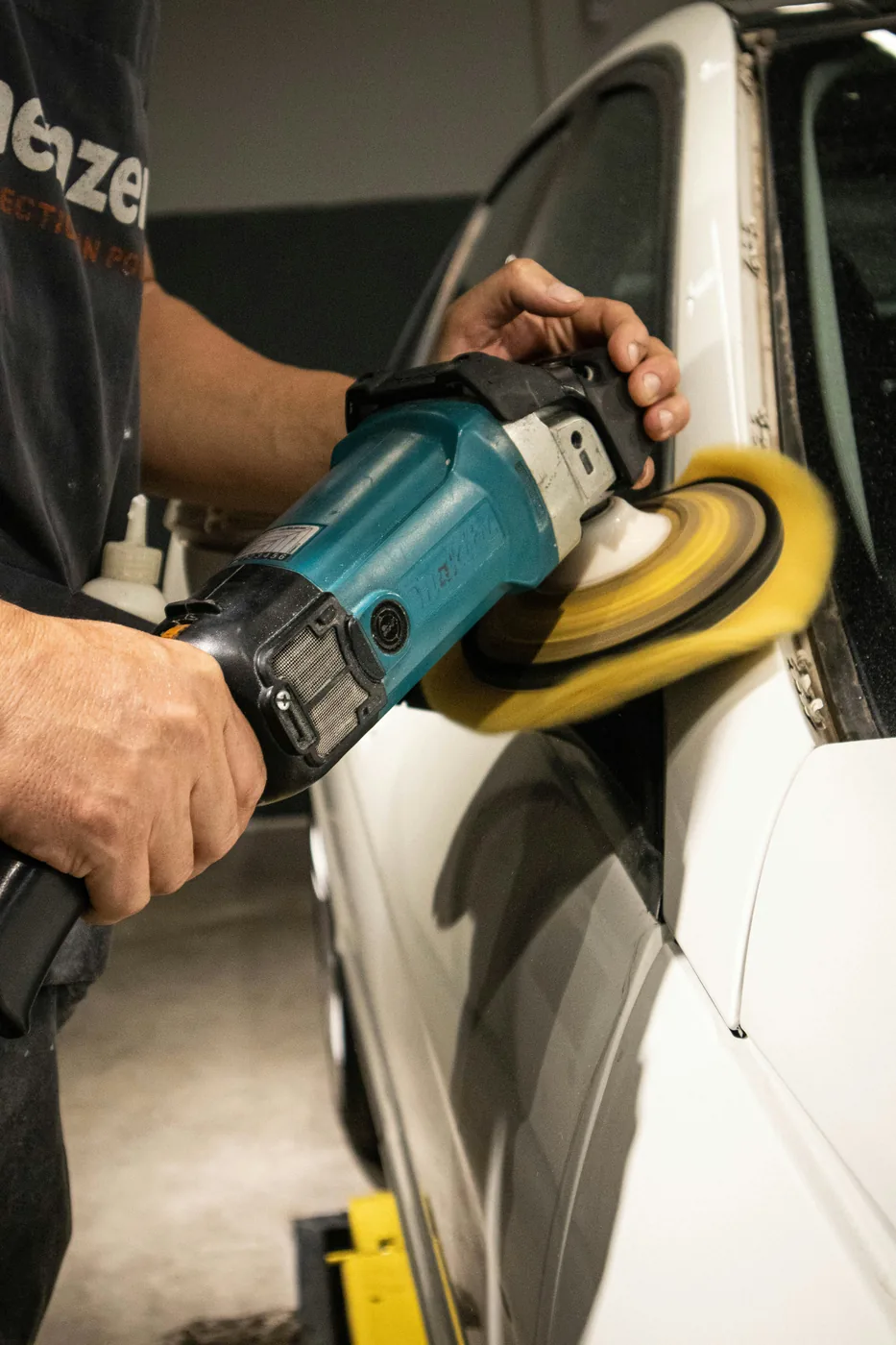 Machine polishing a vehicle panel during paint correction